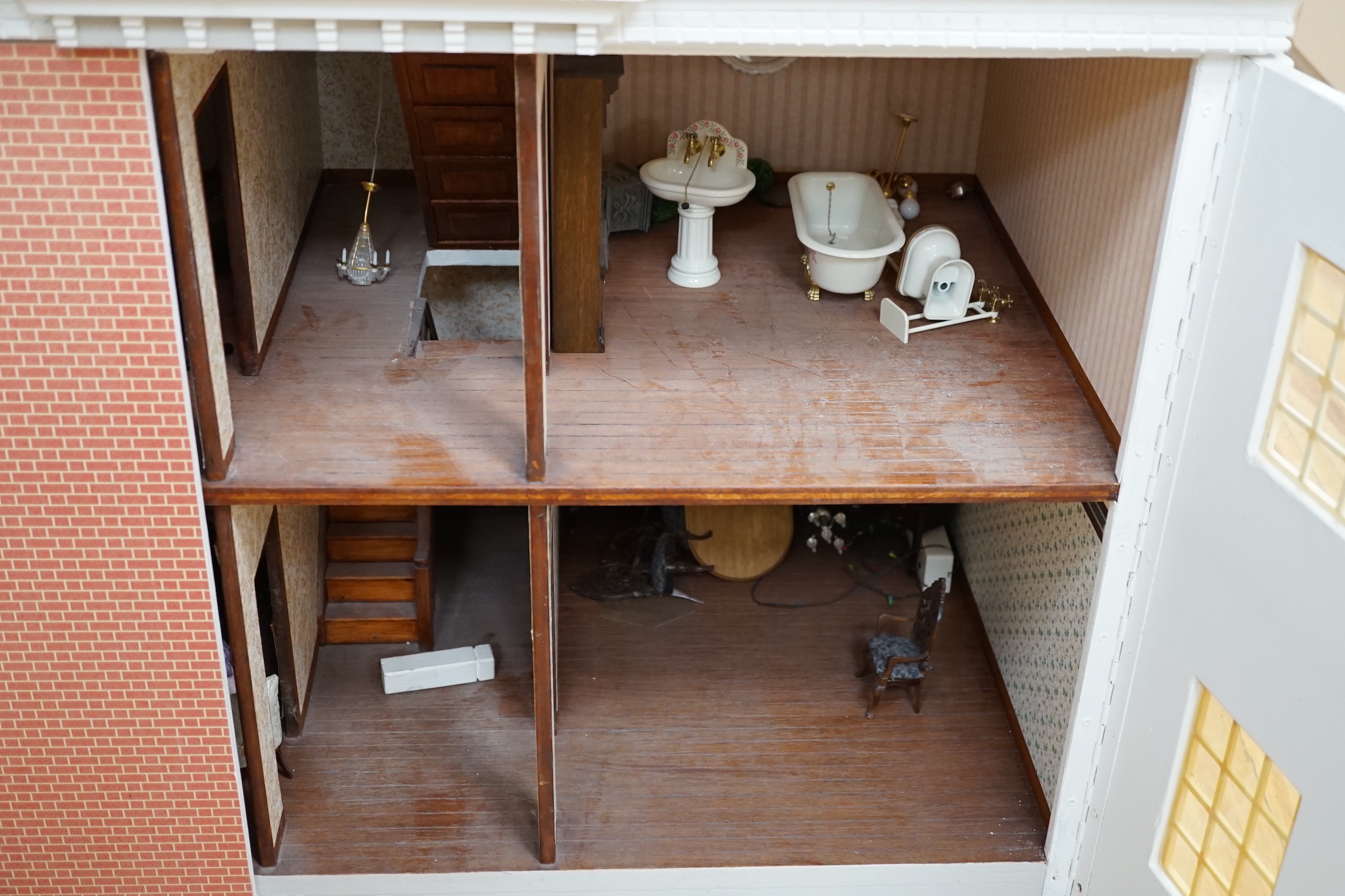 A modern Georgian style dolls house, with two front opening doors, containing six rooms with furnishings, figures, and electric lighting, together with a dolls shop, containing two rooms, furnishings, and accessories, et